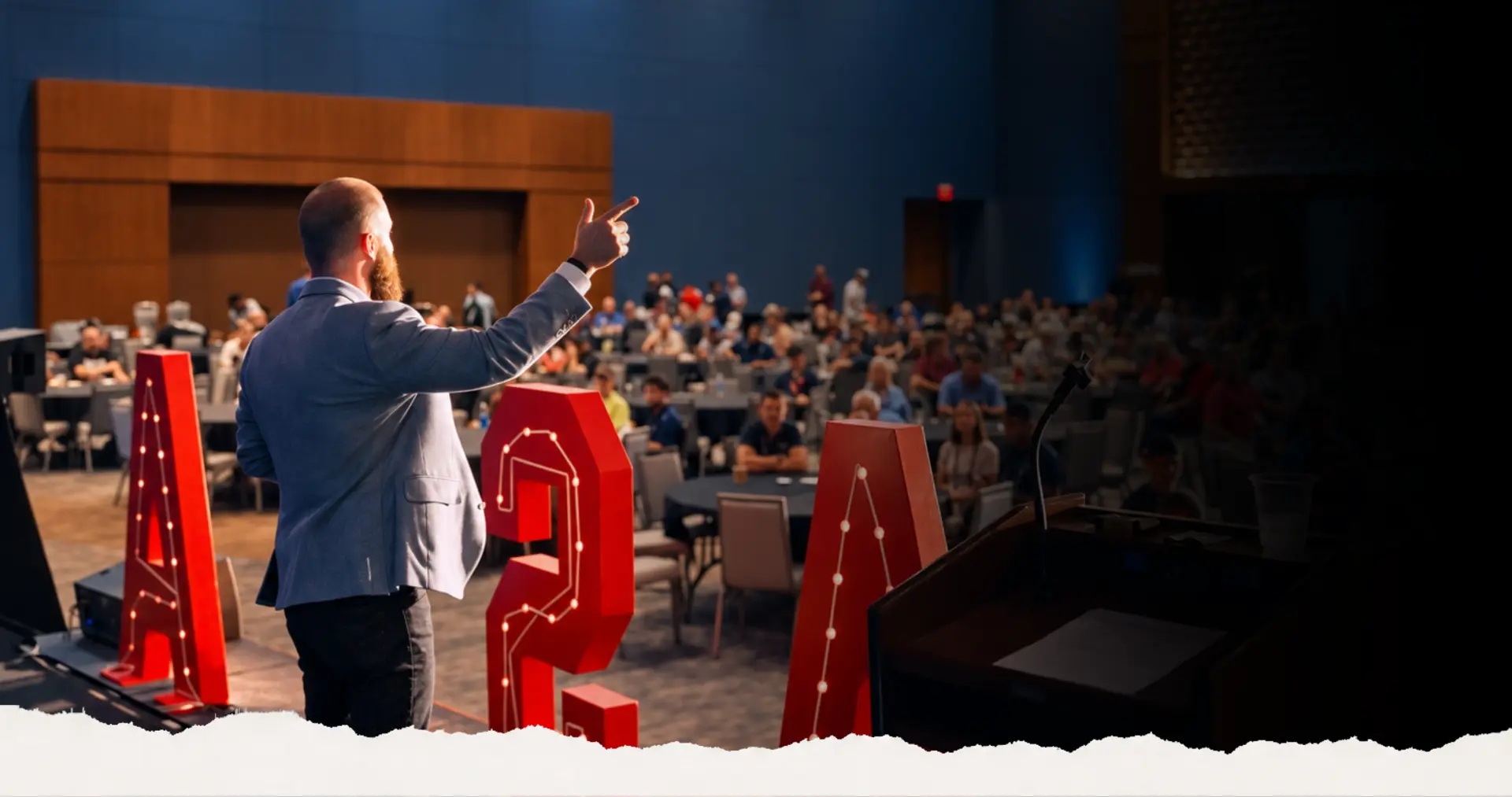 A Limitless Leadership speaker addressing a packed conference audience on stage